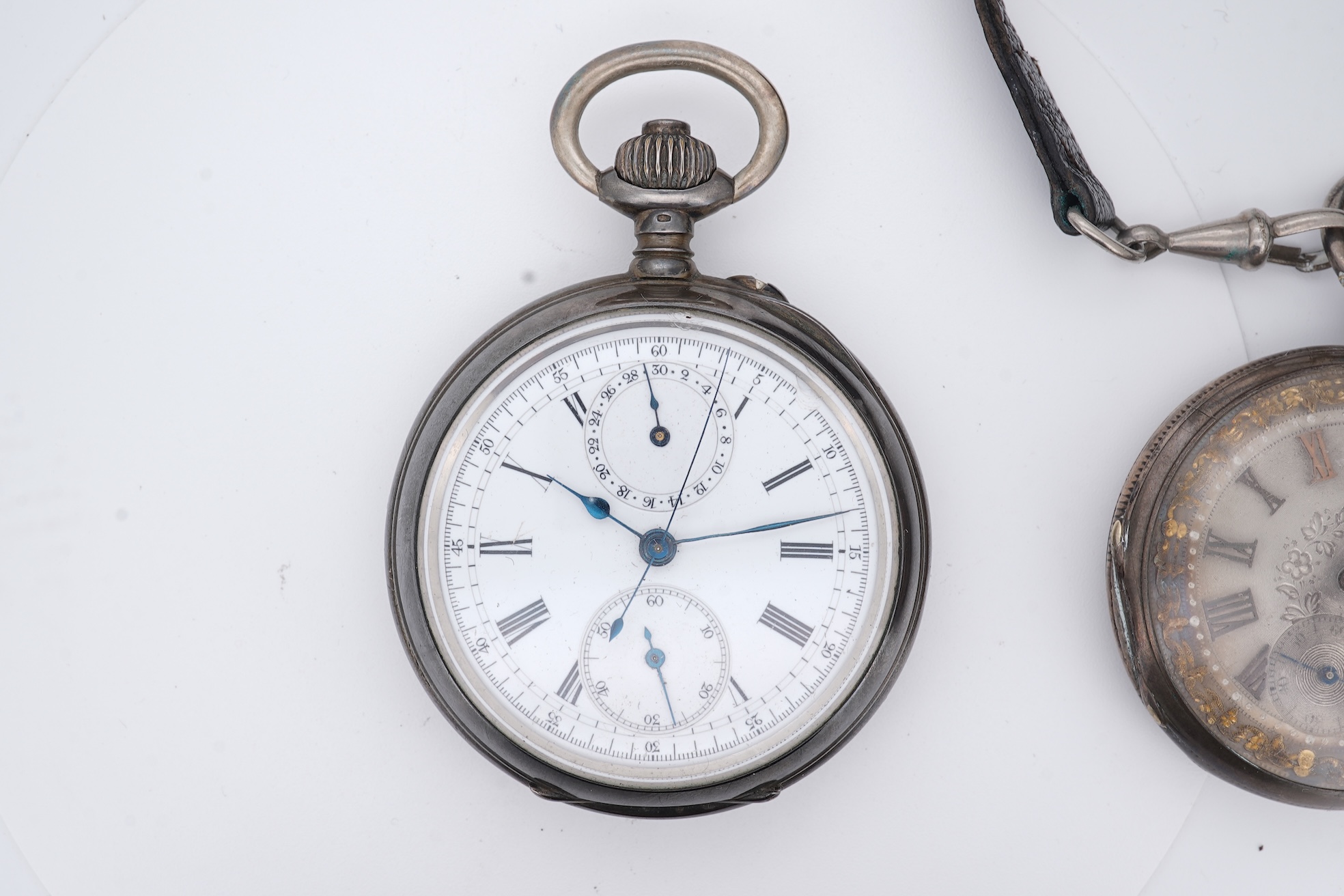 An early 20th century continental 800 standard white metal open faced chronograph pocket watch, with Roman numerals and two subsidiary dials, case diameter 50mm, together with a similar smaller white metal open faced poc